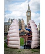 A woman standing in front of a large pair of inflated lungs 