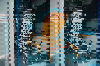 Inside view of an ambulance showing a yellow stretcher with black padding